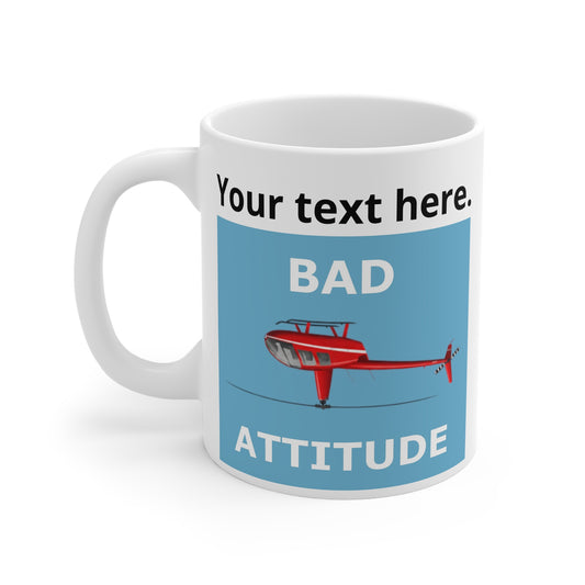 A white ceramic mug with a funny helicopter graphic design featuring a light blue panel, a red helicopter upside down, a custom text section and the text'BAD ATTITUDE'.